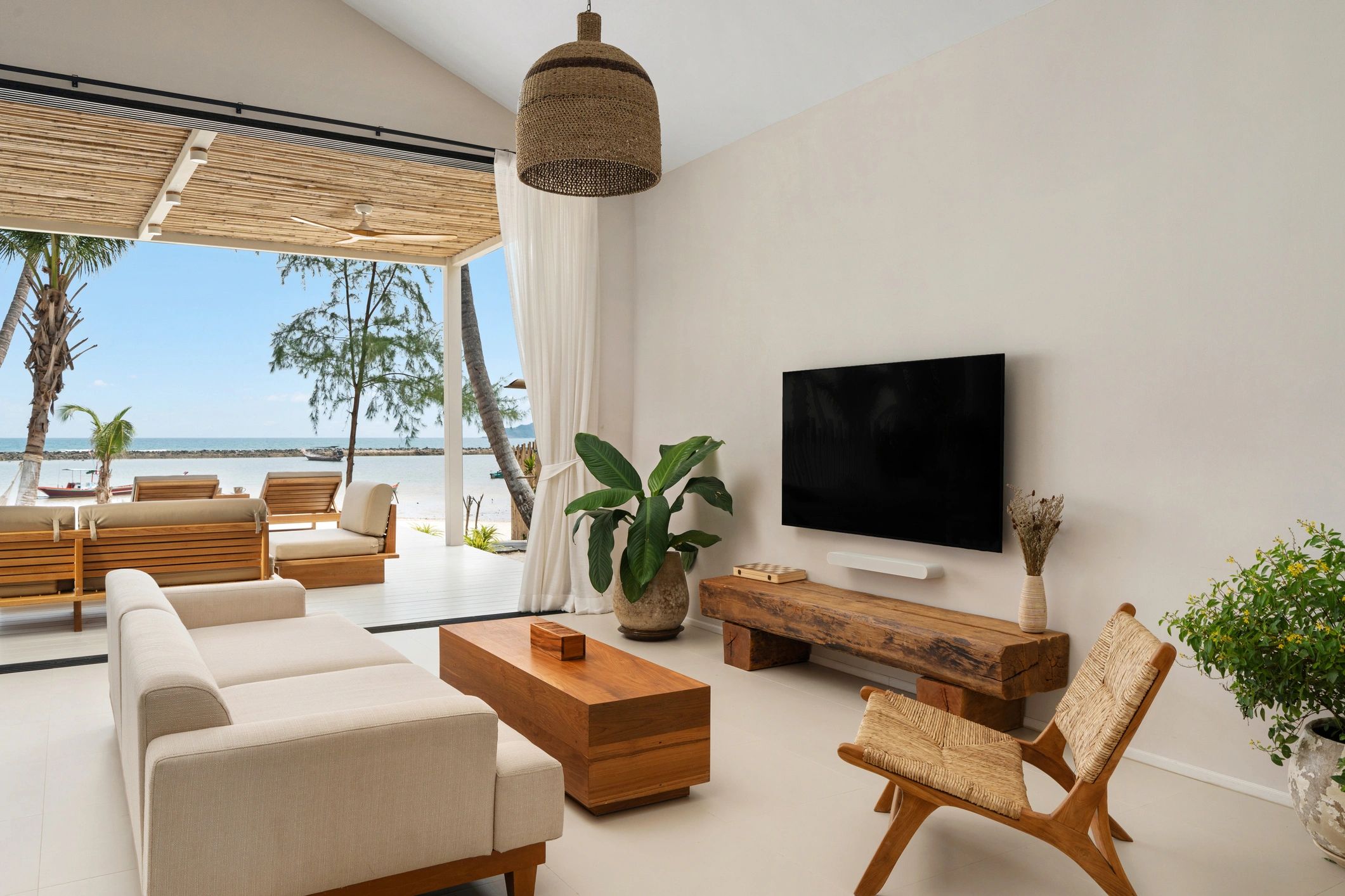 High-ceiling white living room with a modern blue-burning fireplace and refined contemporary styling