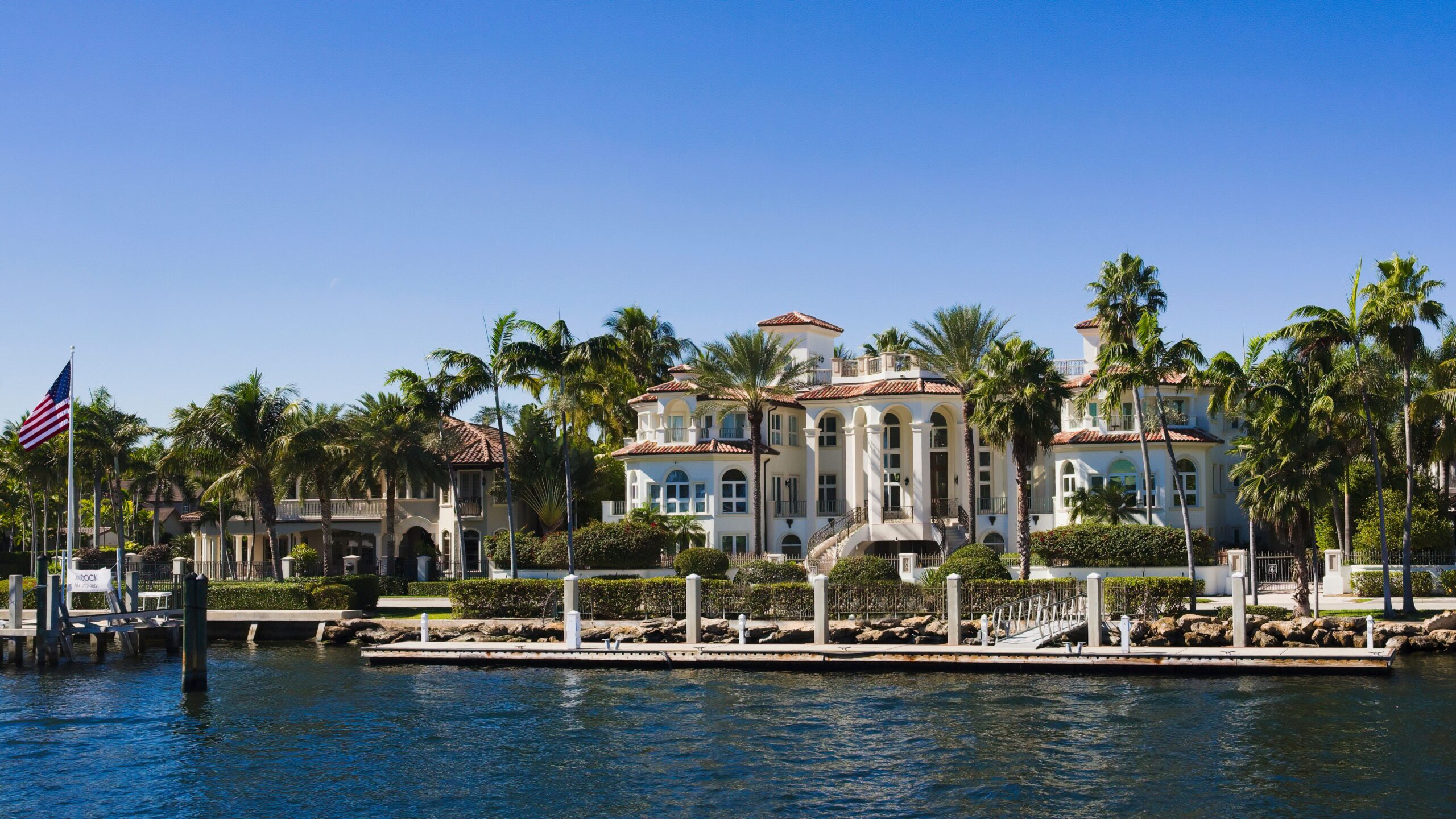 Florida home near tropical landscaping and blue skies